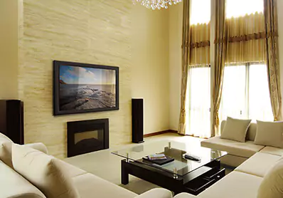 Cozy living room with a wall-mounted framed smart mirror TV above a fireplace.