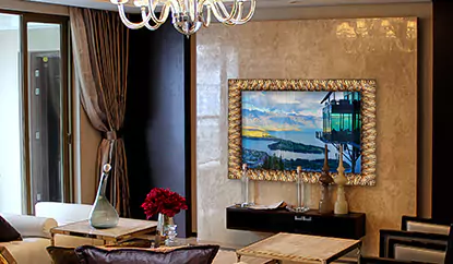 A gold framed mirror TV is mounted on a ceramic wall in a sophisticated living room.